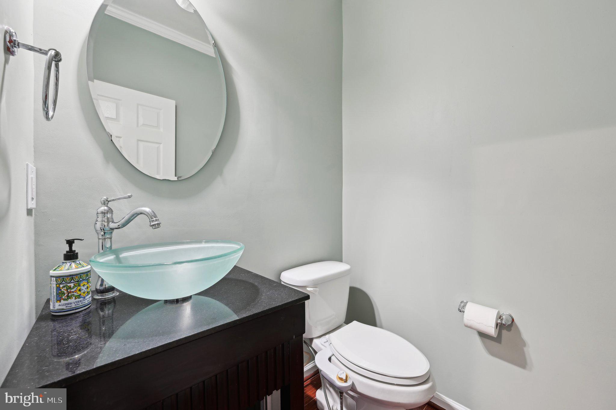 9552 Chaton Road Laurel, MD 20723 - Photo 18 of 53 a bathroom with a toilet a sink and mirror