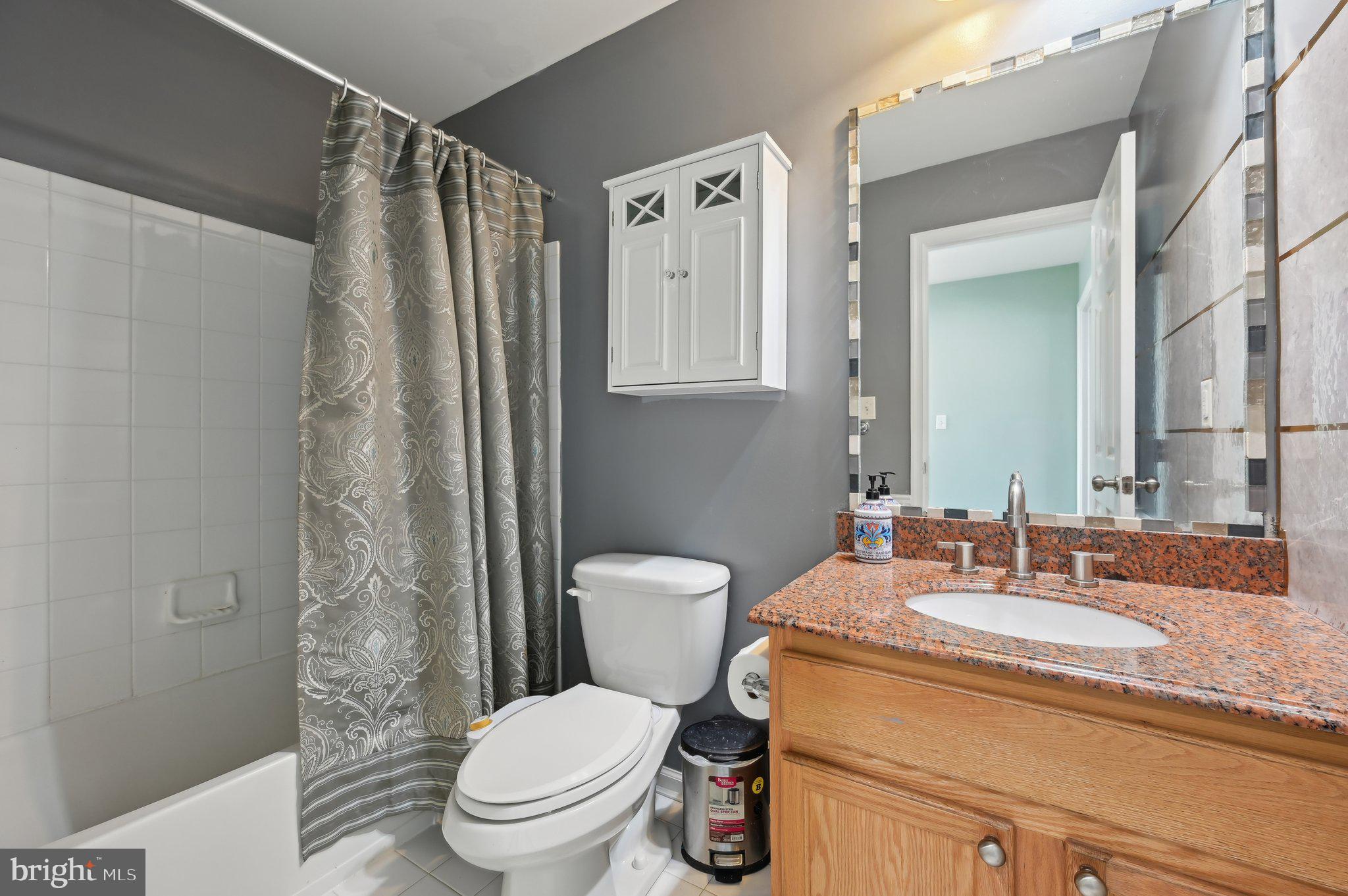 9552 Chaton Road Laurel, MD 20723 - Photo 37 of 53 a bathroom with a granite countertop sink toilet and shower