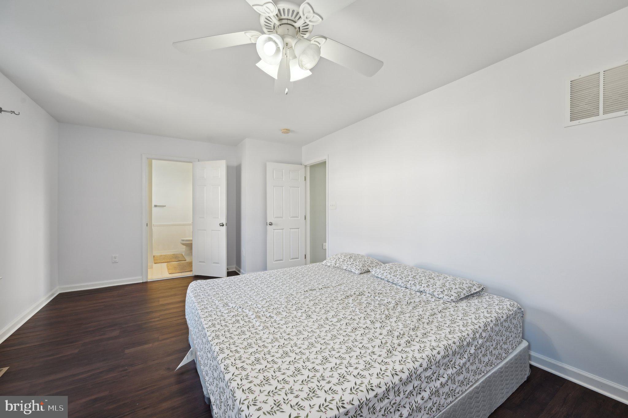 9552 Chaton Road Laurel, MD 20723 - Photo 40 of 53 a bedroom with a large bed and a chandelier