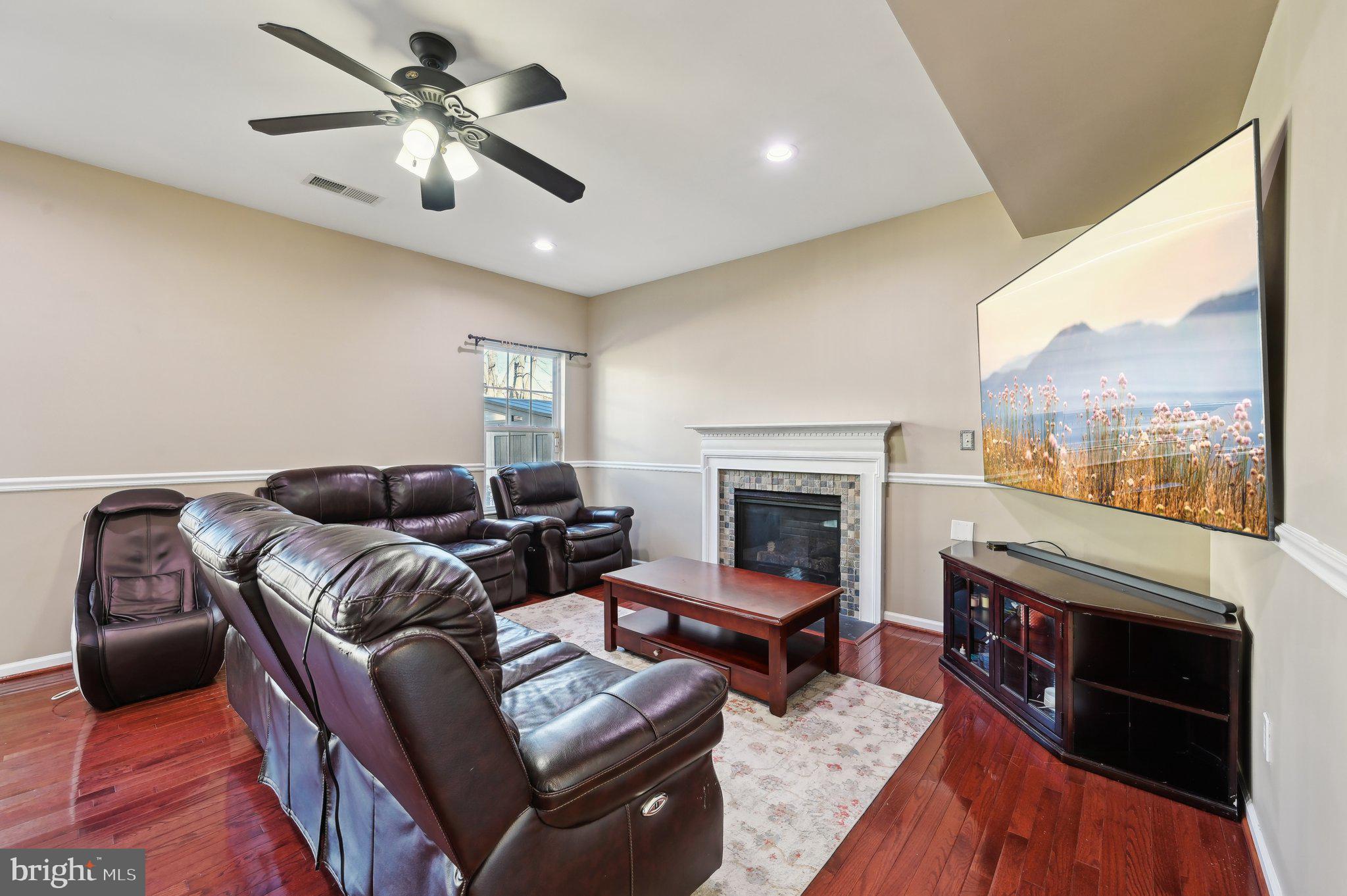 9552 Chaton Road Laurel, MD 20723 - Photo 4 of 53 a living room with furniture a fireplace and a large window