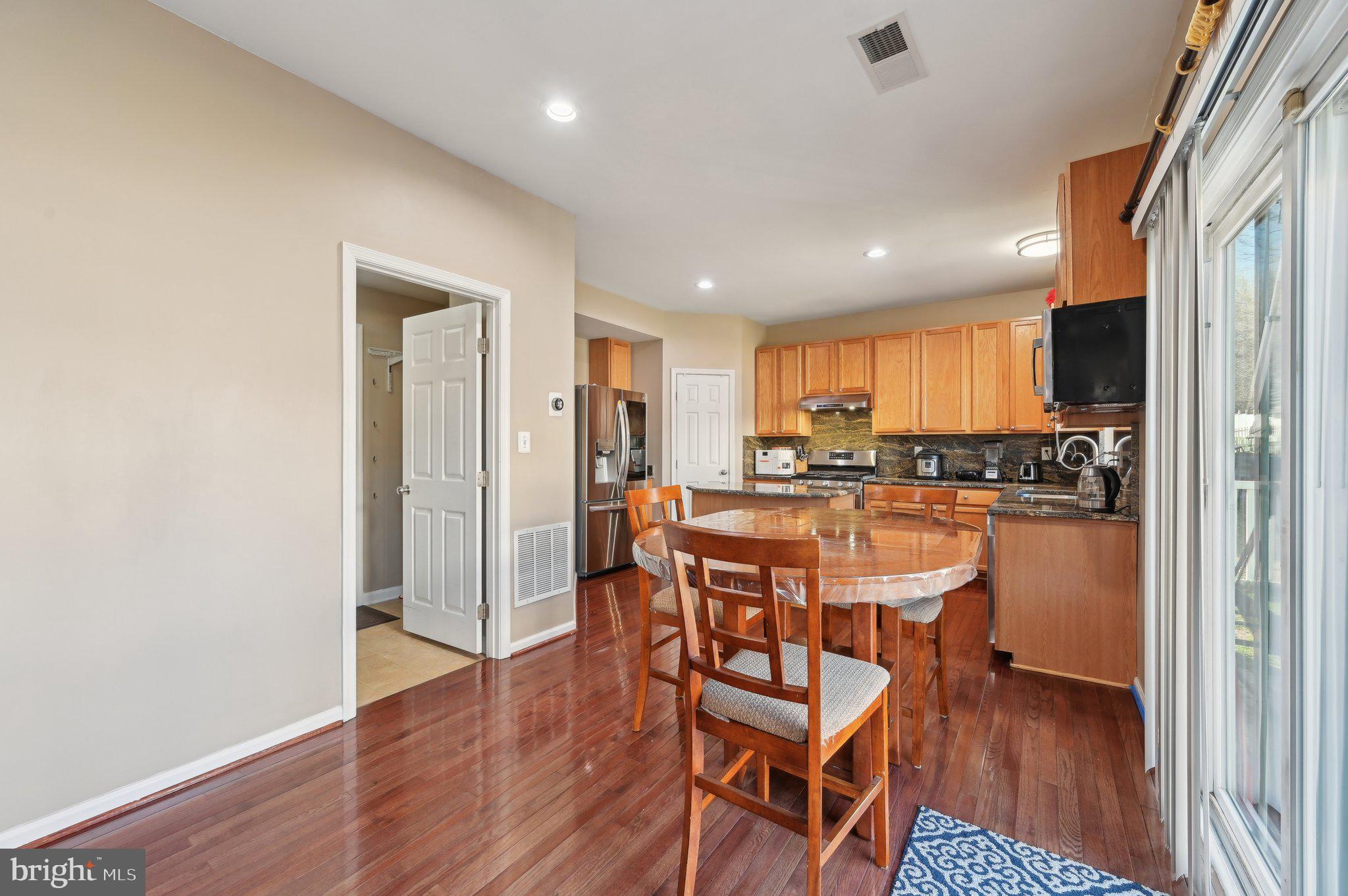 9552 Chaton Road Laurel, MD 20723 - Photo 9 of 53 a view of a dining room with furniture and wooden floor