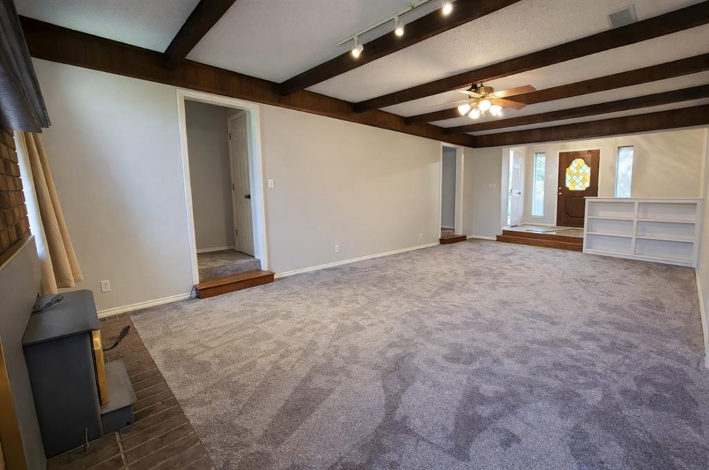 2302 Shiloh Street Denison, TX 75020 - Photo 6 of 16 wooden floor in an empty room with a window