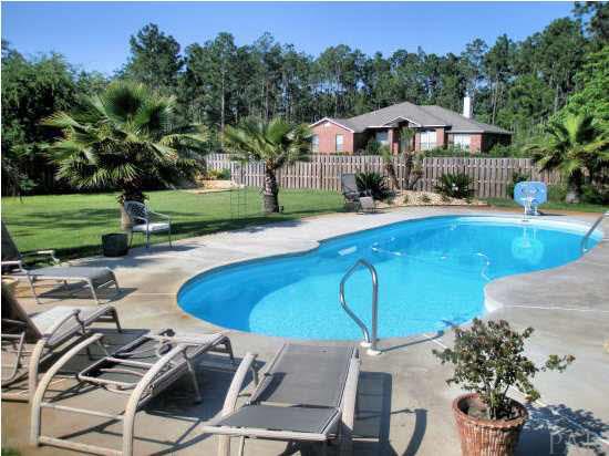 7151 Riverview Road Navarre, FL 32566 - Photo 2 of 18 Absolutely stunning backyard with heated in-ground ?salt water? swimming pool