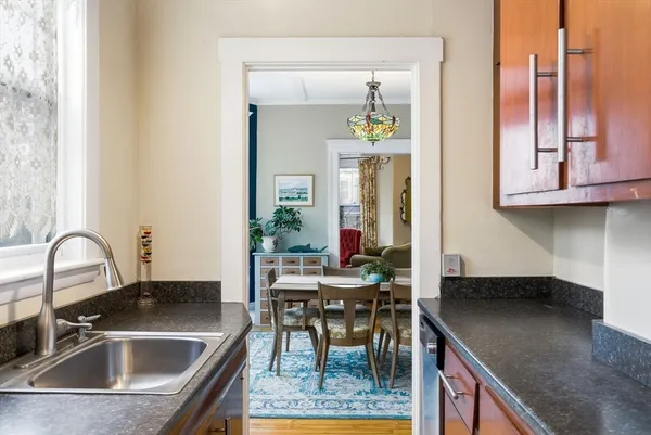 a kitchen with a sink a counter and chairs