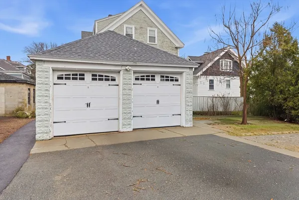 a view of a house with a yard and garage