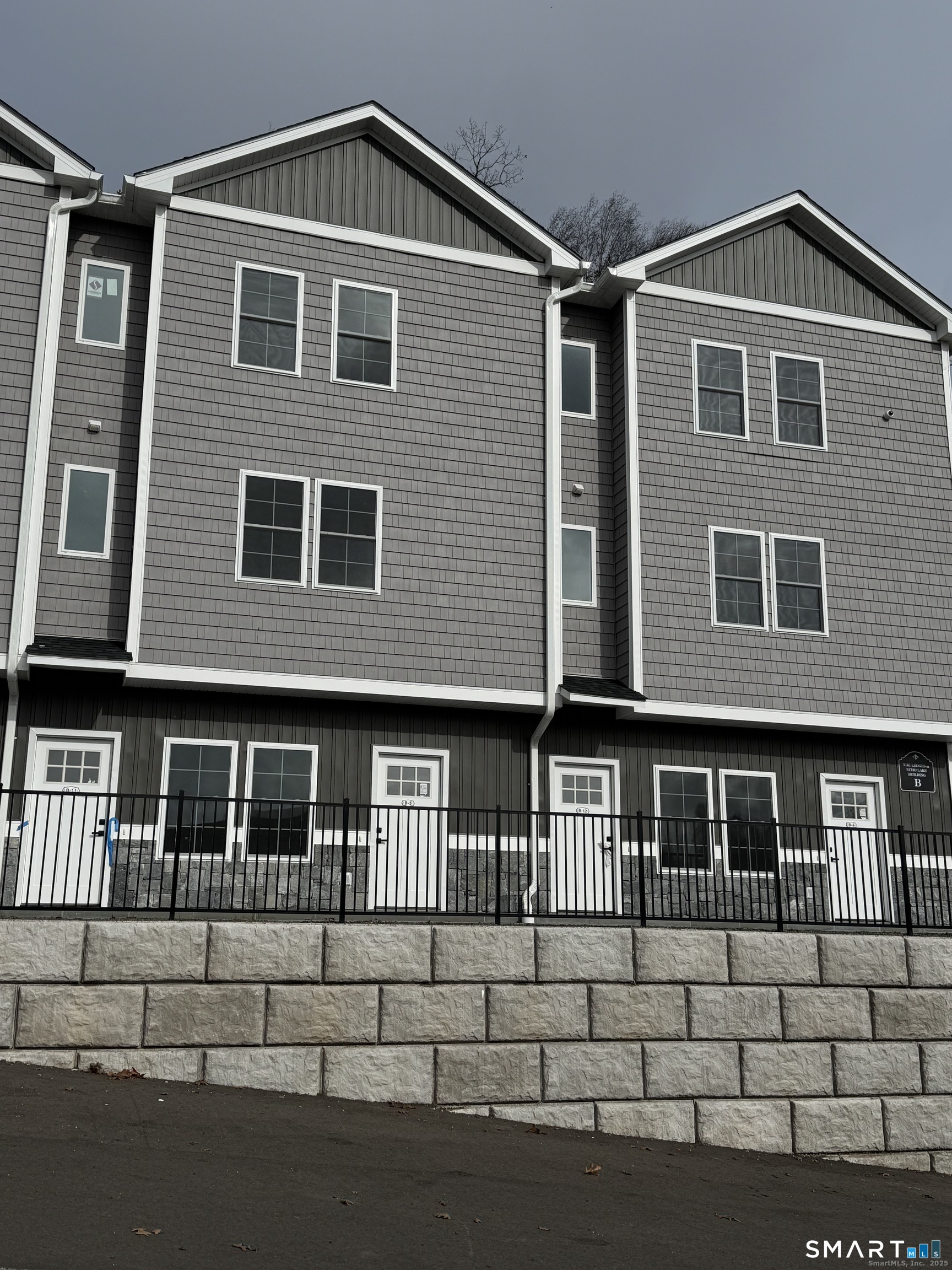 243 Echo Lake Road, Unit B10 Watertown, CT 06795 - Photo 3 of 10 a front view of a house with a yard