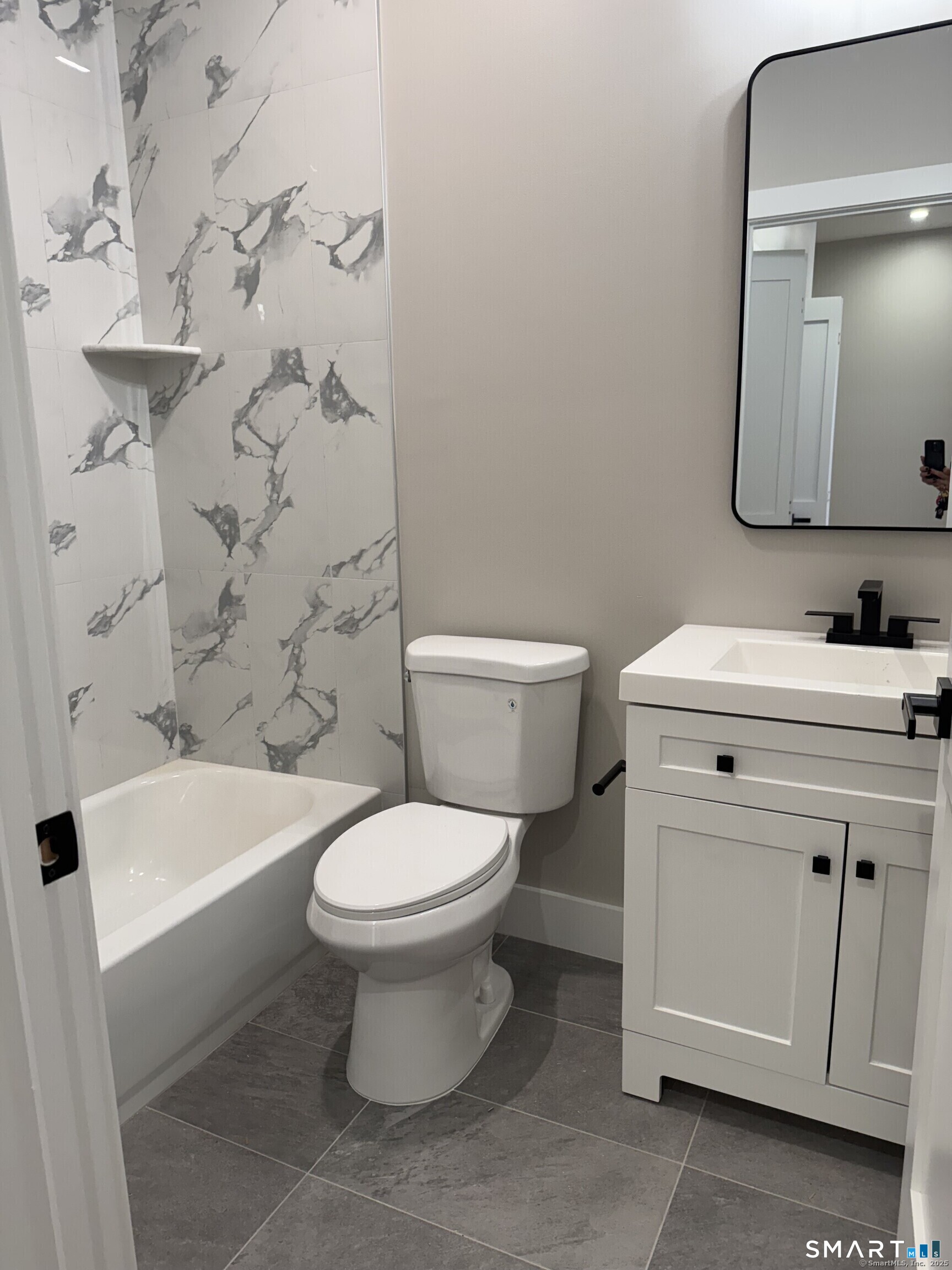 243 Echo Lake Road, Unit B10 Watertown, CT 06795 - Photo 9 of 10 a white toilet sitting next to a bathroom sink