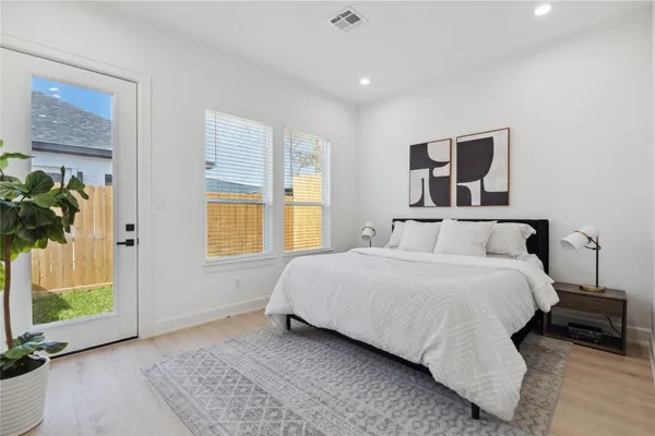 a bedroom with a bed and a window
