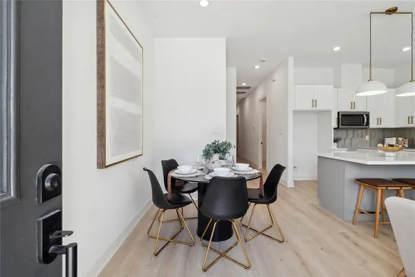 a view of a dining room with furniture and wooden floor