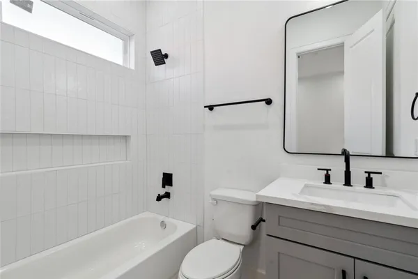 a bathroom with a sink a toilet and bathtub