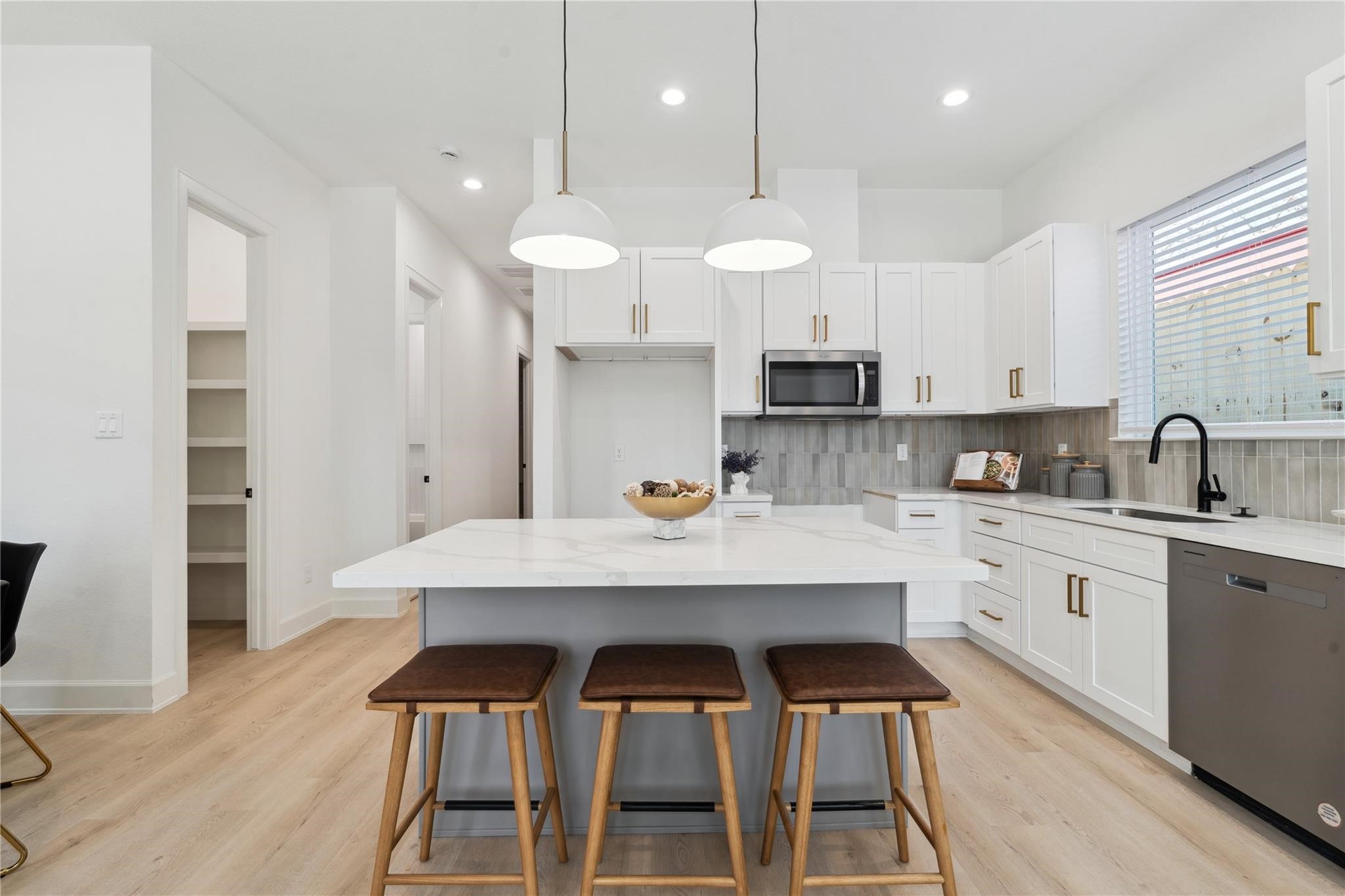 6528 Weston Street, Unit A Houston, TX 77021 - Photo 7 of 25 a kitchen with stainless steel appliances a table chairs stove and cabinets