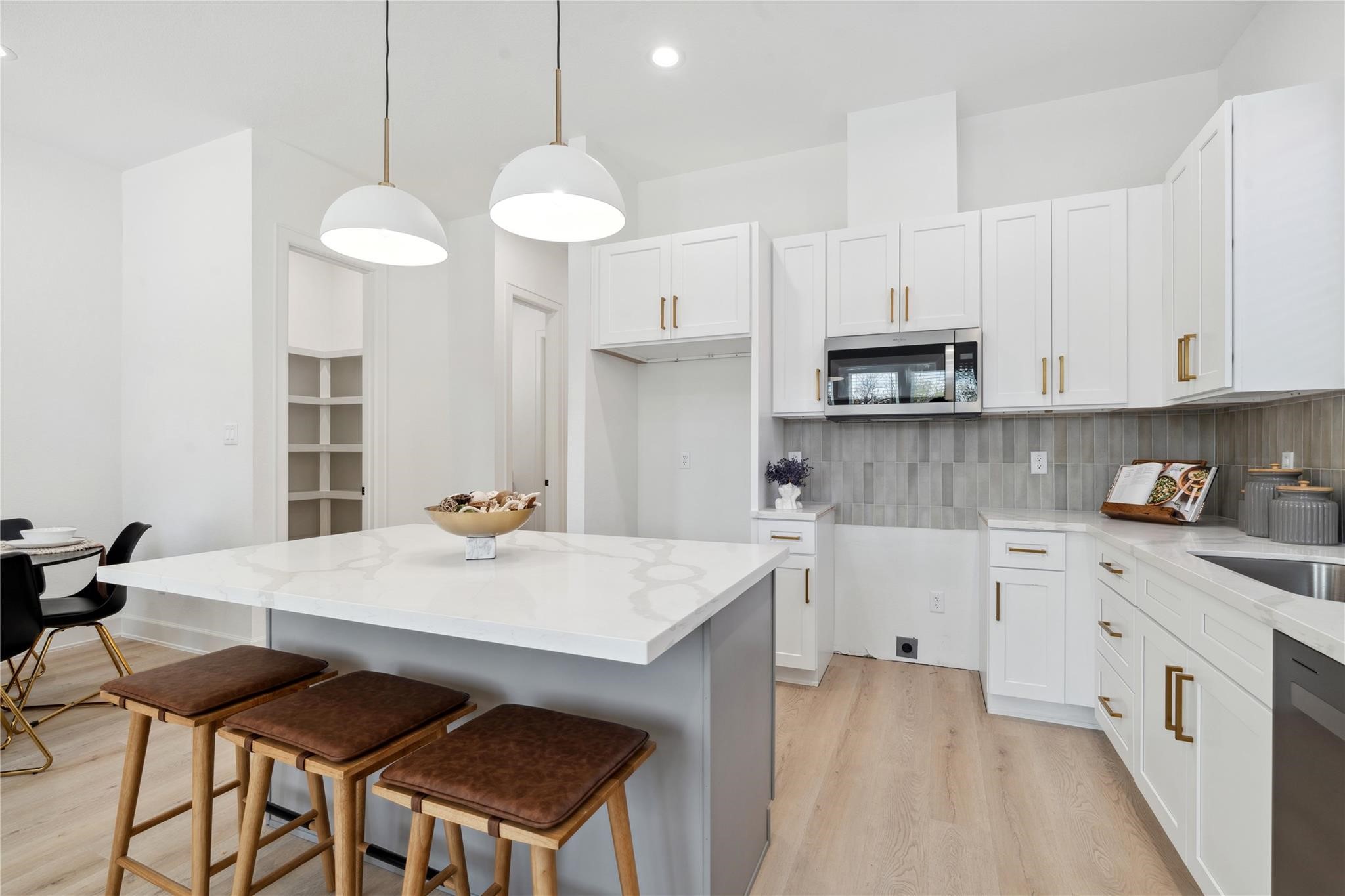 6528 Weston Street, Unit A Houston, TX 77021 - Photo 8 of 25 a kitchen that has a cabinets a sink dishwasher a stove and a refrigerator with wooden floor