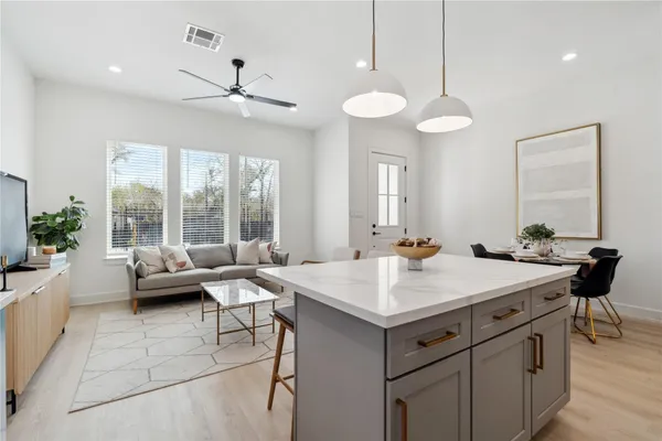 a room with a table chairs and couches