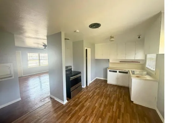 a kitchen with a refrigerator and a stove top oven