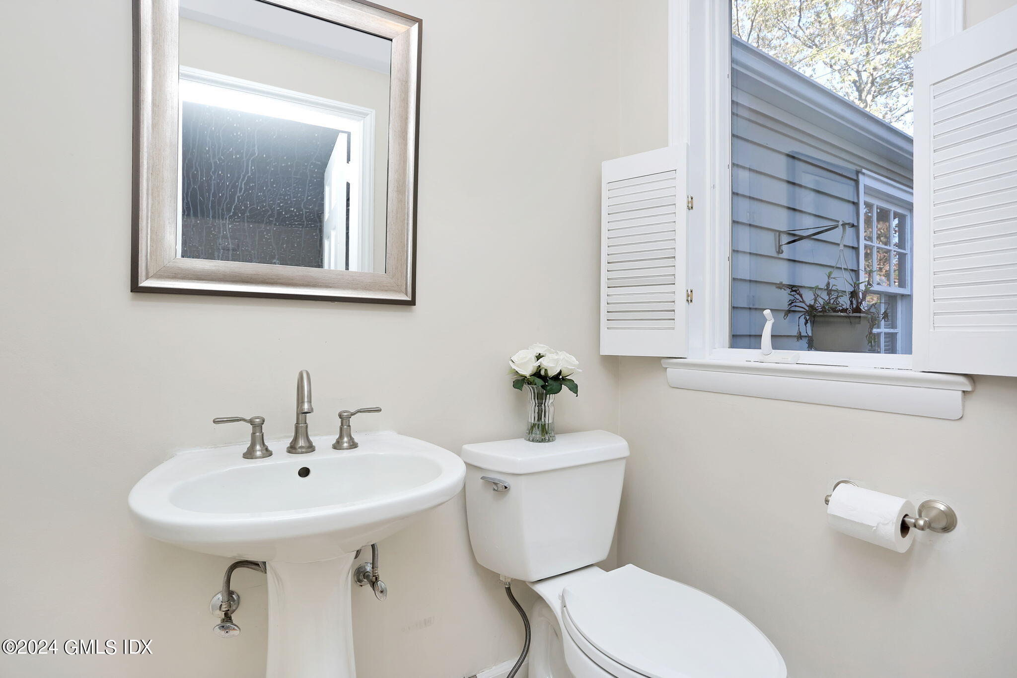44 Hendrie Avenue Riverside, CT 06878 - Photo 14 of 40 a bathroom with a toilet a sink and mirror