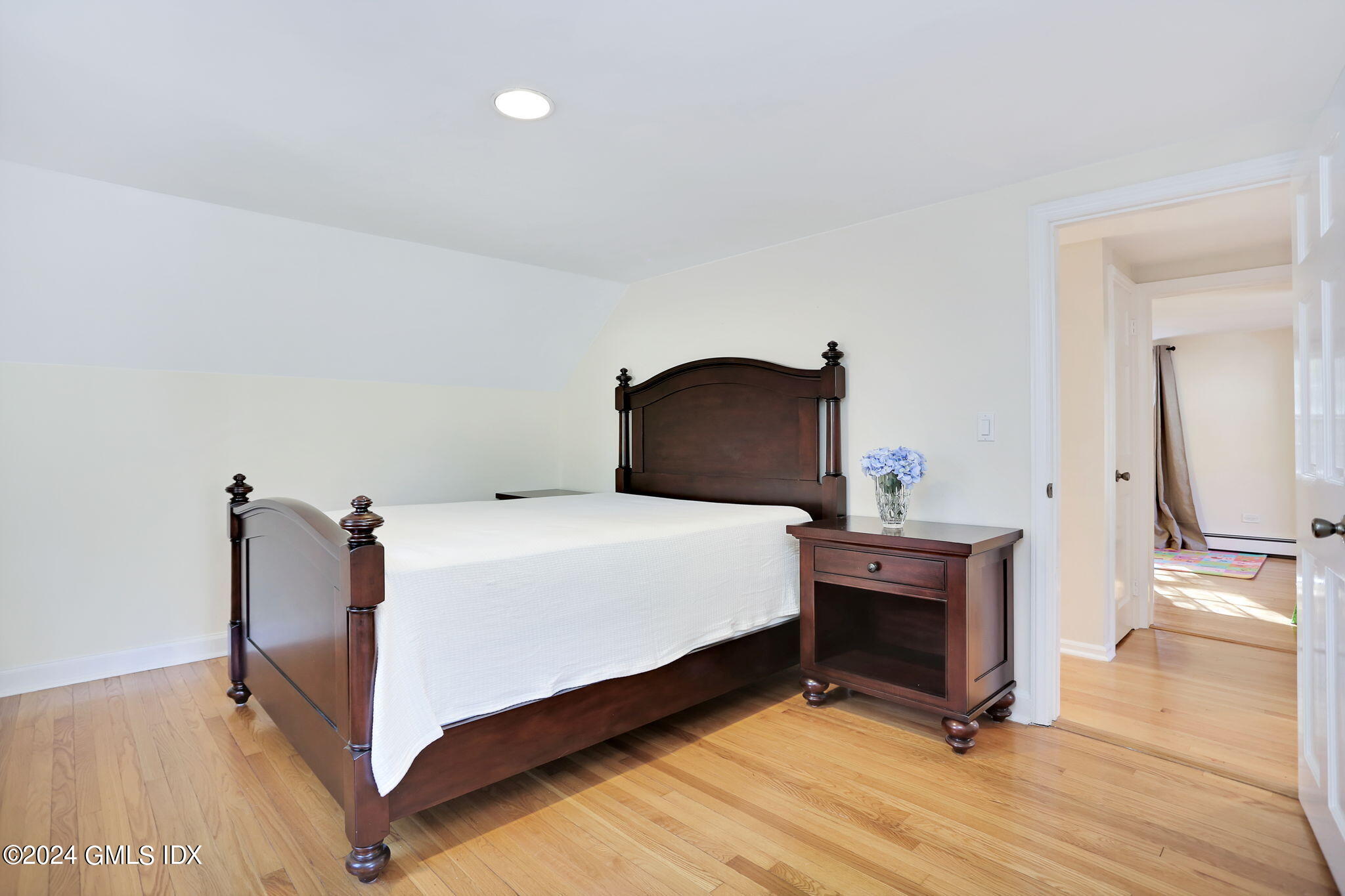 44 Hendrie Avenue Riverside, CT 06878 - Photo 17 of 40 a bedroom with a bed and a flat tv screen on wall