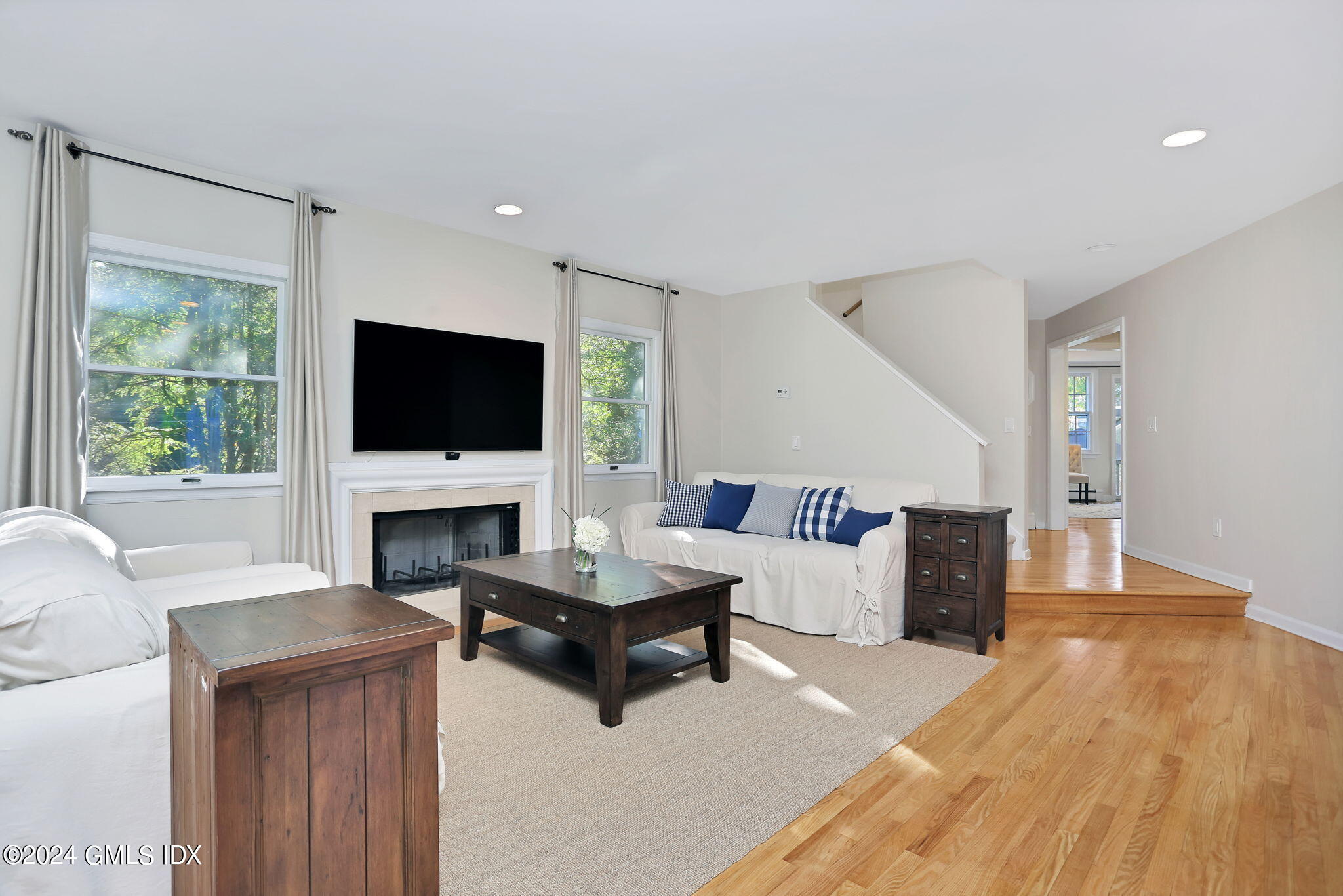 44 Hendrie Avenue Riverside, CT 06878 - Photo 5 of 40 a living room with furniture a fireplace and a flat screen tv