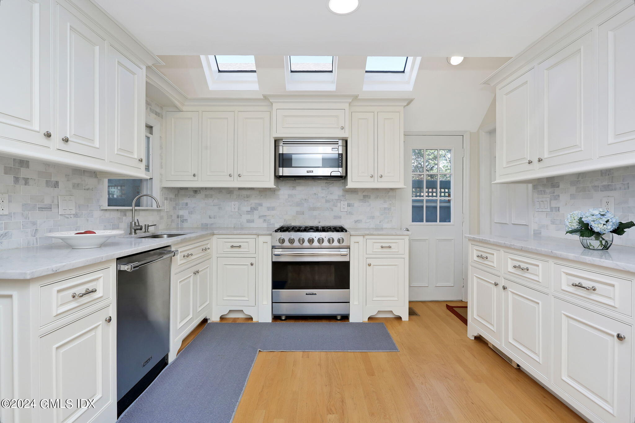 44 Hendrie Avenue Riverside, CT 06878 - Photo 6 of 40 a kitchen with stainless steel appliances granite countertop a stove and white cabinets