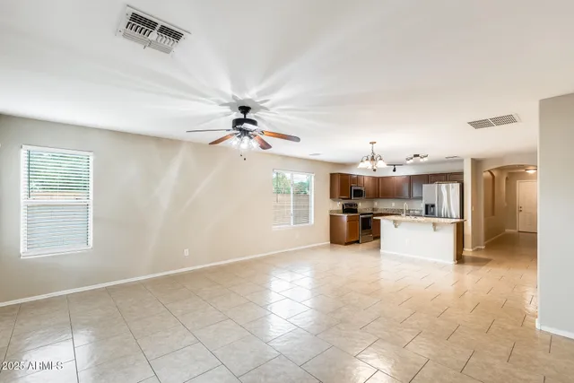 a kitchen with stainless steel appliances granite countertop a sink refrigerator and microwave