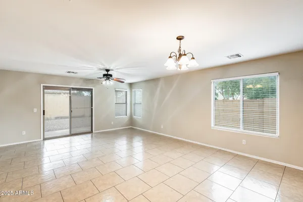a view of a livingroom with a chandelier furniture and windows