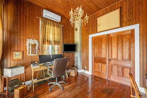 a work room with wooden floor and furniture