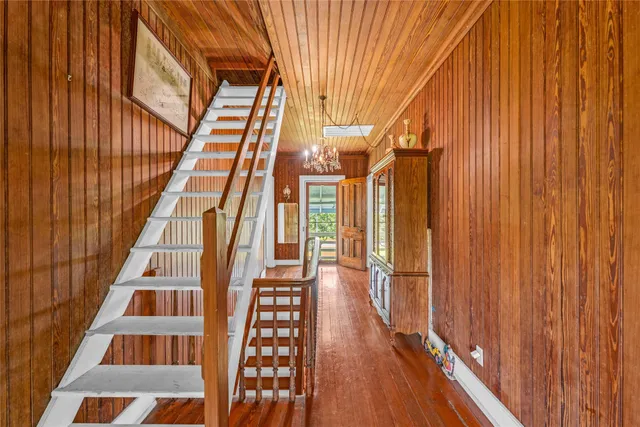 a view of staircase with white walls and wooden floor