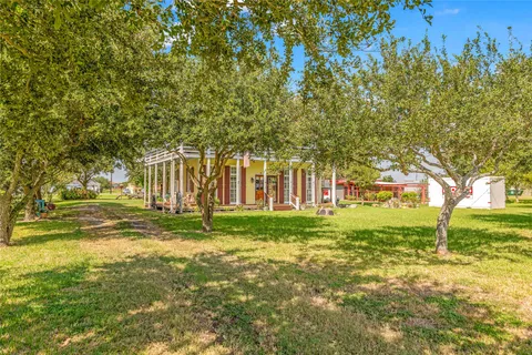 a view of swimming pool with trees and wooden fence