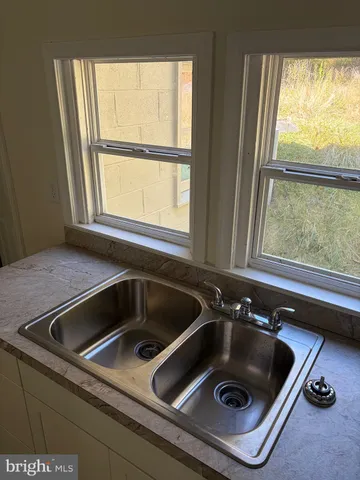 a stove top oven sitting inside of a kitchen