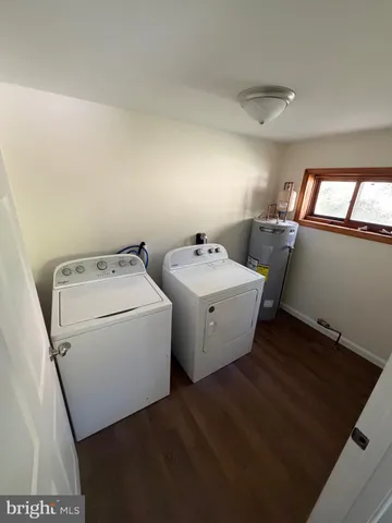 an empty room with wooden floor ceiling fan and windows