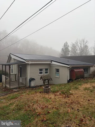 a house that has a tree in front of it