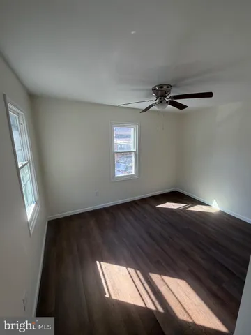 a view of a ceiling fan and wooden floor