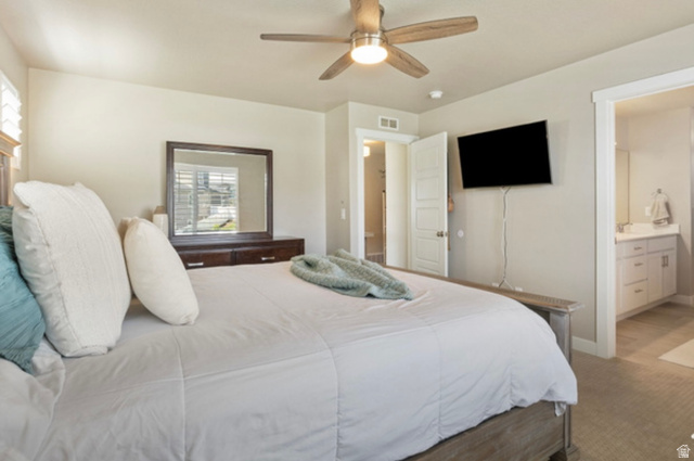 1295 East Granite Peak Road Eagle Mountain, UT 84005 - Photo 17 of 35 Carpeted bedroom featuring a ceiling fan, window with white plantation shutters, and a white six-panel door