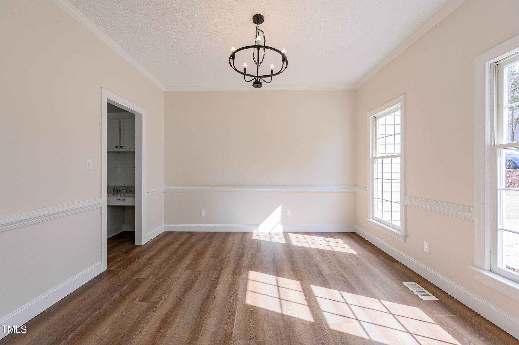 5620 Raddington Street Raleigh, NC 27613 - Photo 13 of 41 a view of empty room with wooden floor and fan