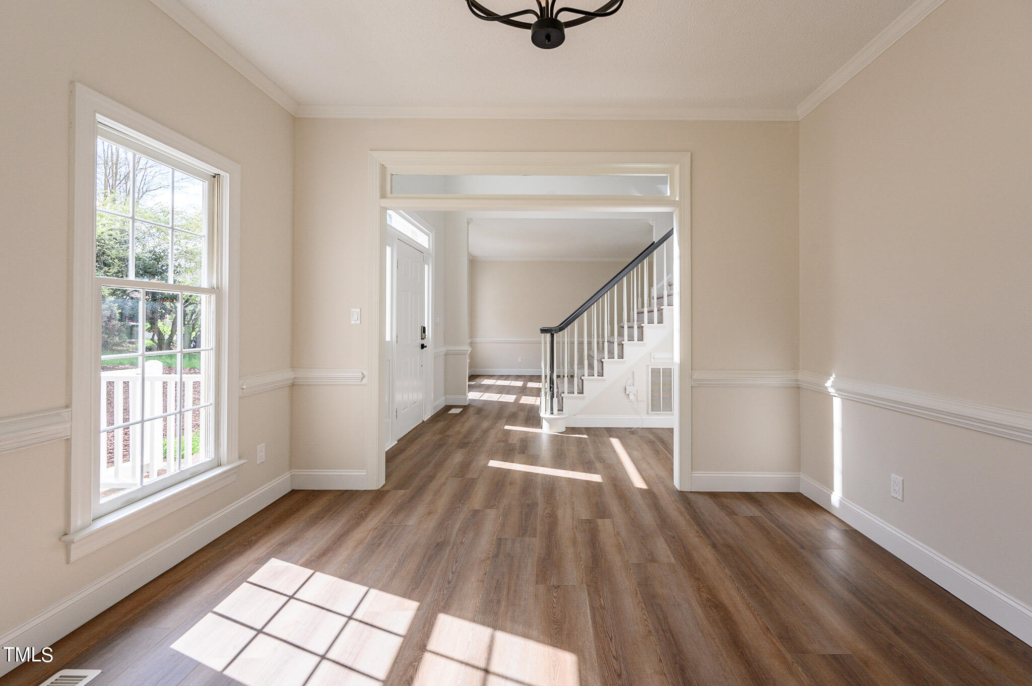 5620 Raddington Street Raleigh, NC 27613 - Photo 14 of 41 a view of entryway and hall with wooden floor