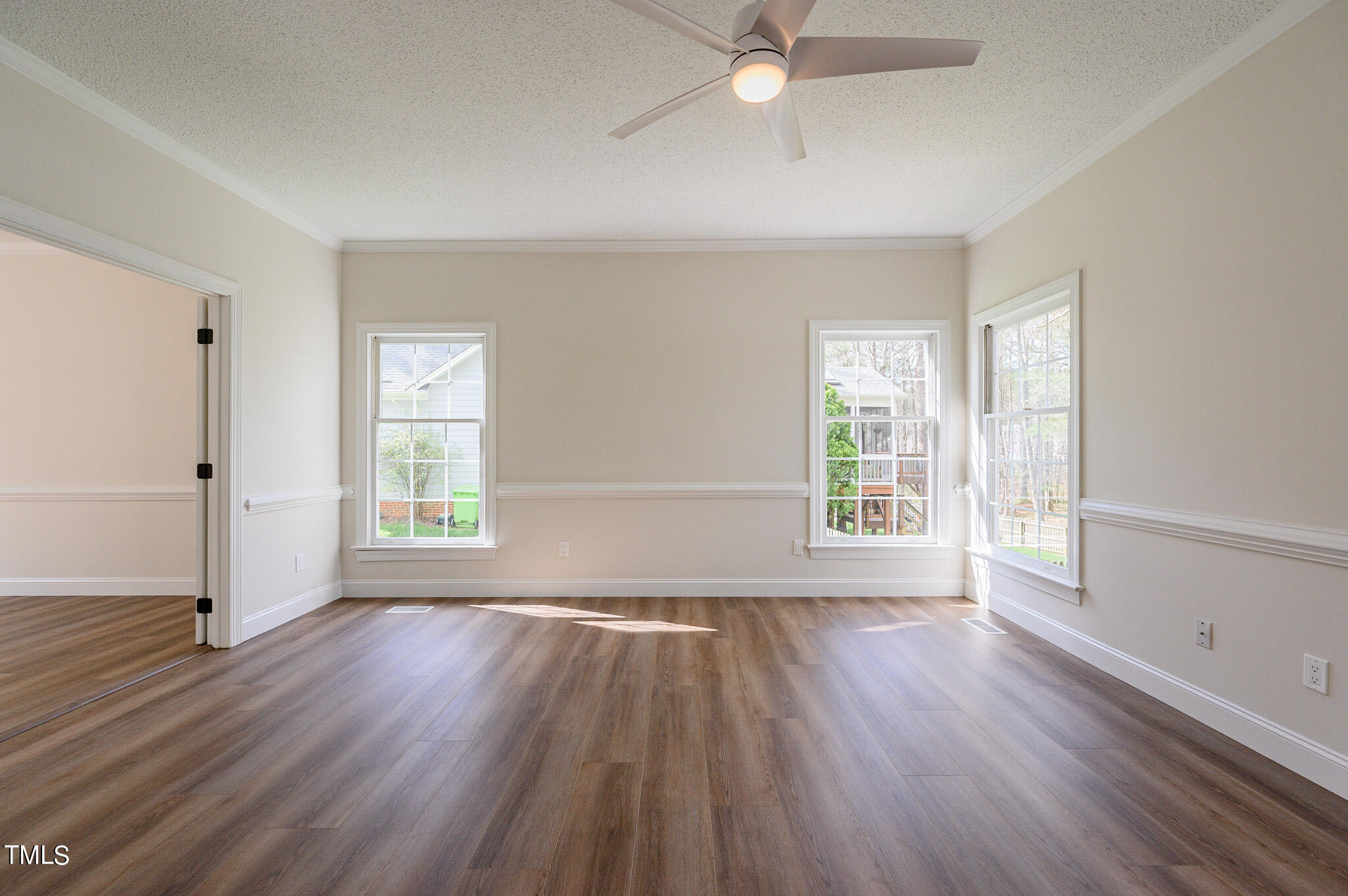 5620 Raddington Street Raleigh, NC 27613 - Photo 16 of 41 a view of an empty room with wooden floor and a window