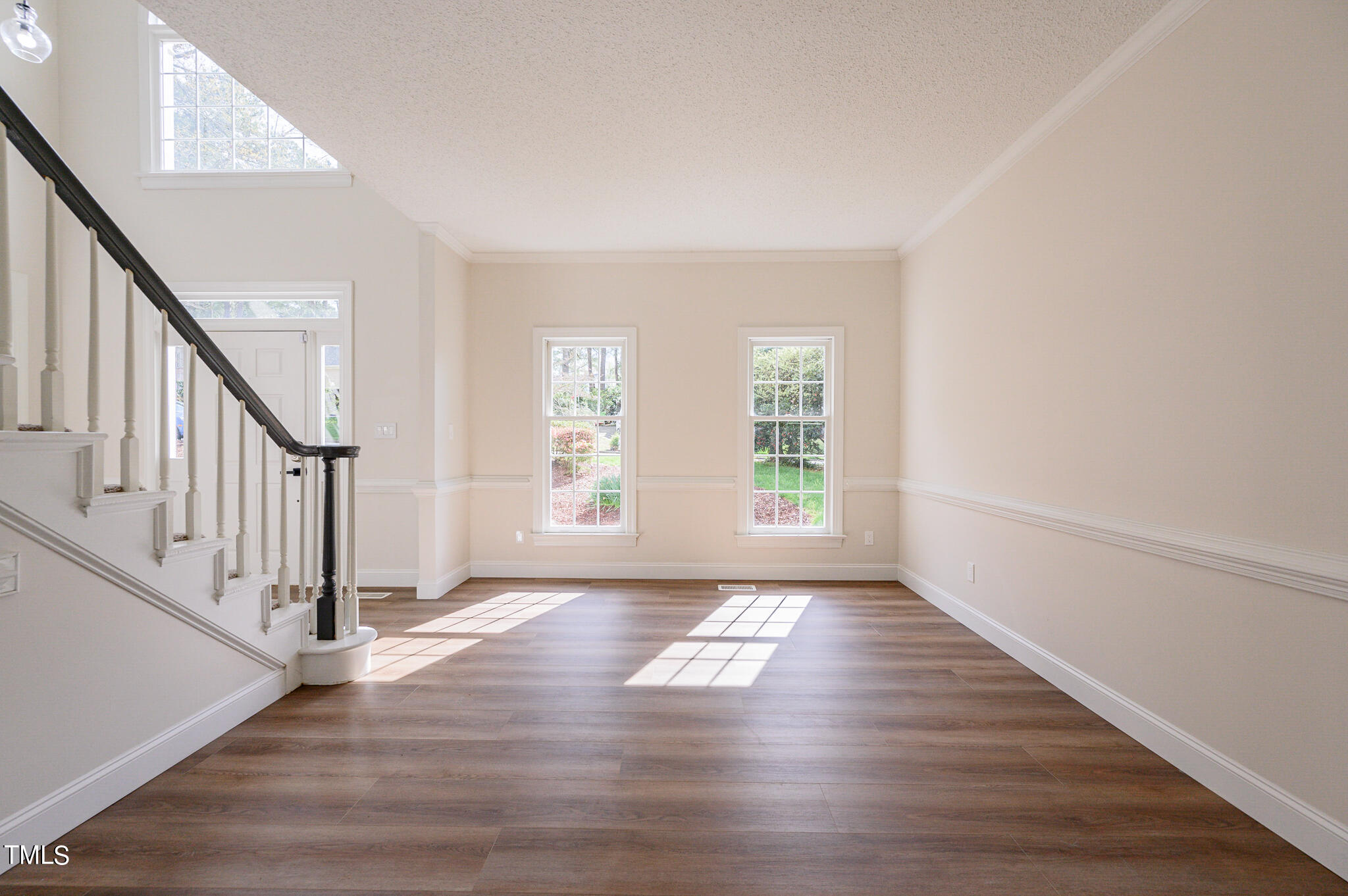 5620 Raddington Street Raleigh, NC 27613 - Photo 18 of 41 a view of an empty room with wooden floor and fan