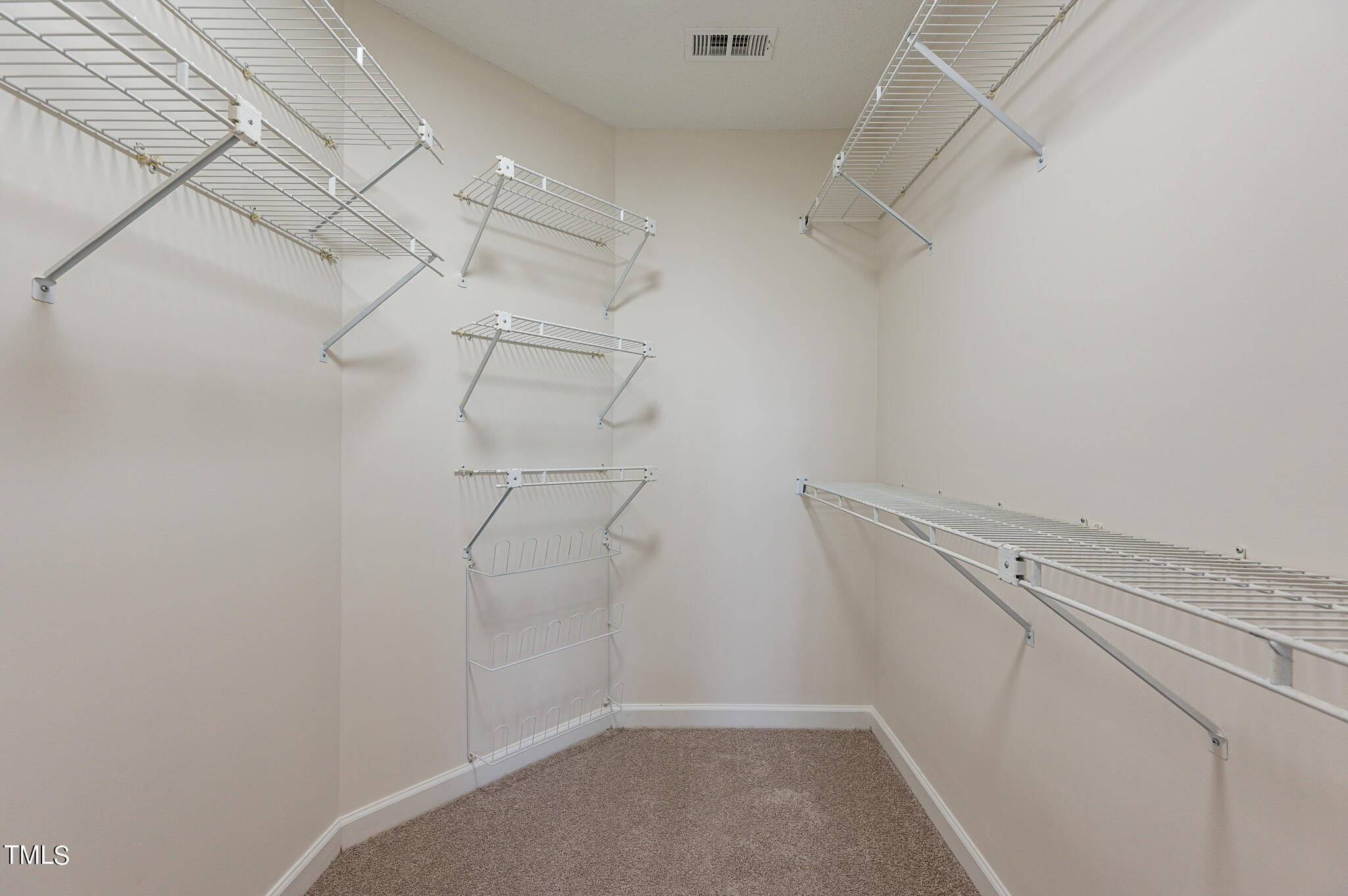 5620 Raddington Street Raleigh, NC 27613 - Photo 25 of 41 a view of a room with racks on the wall