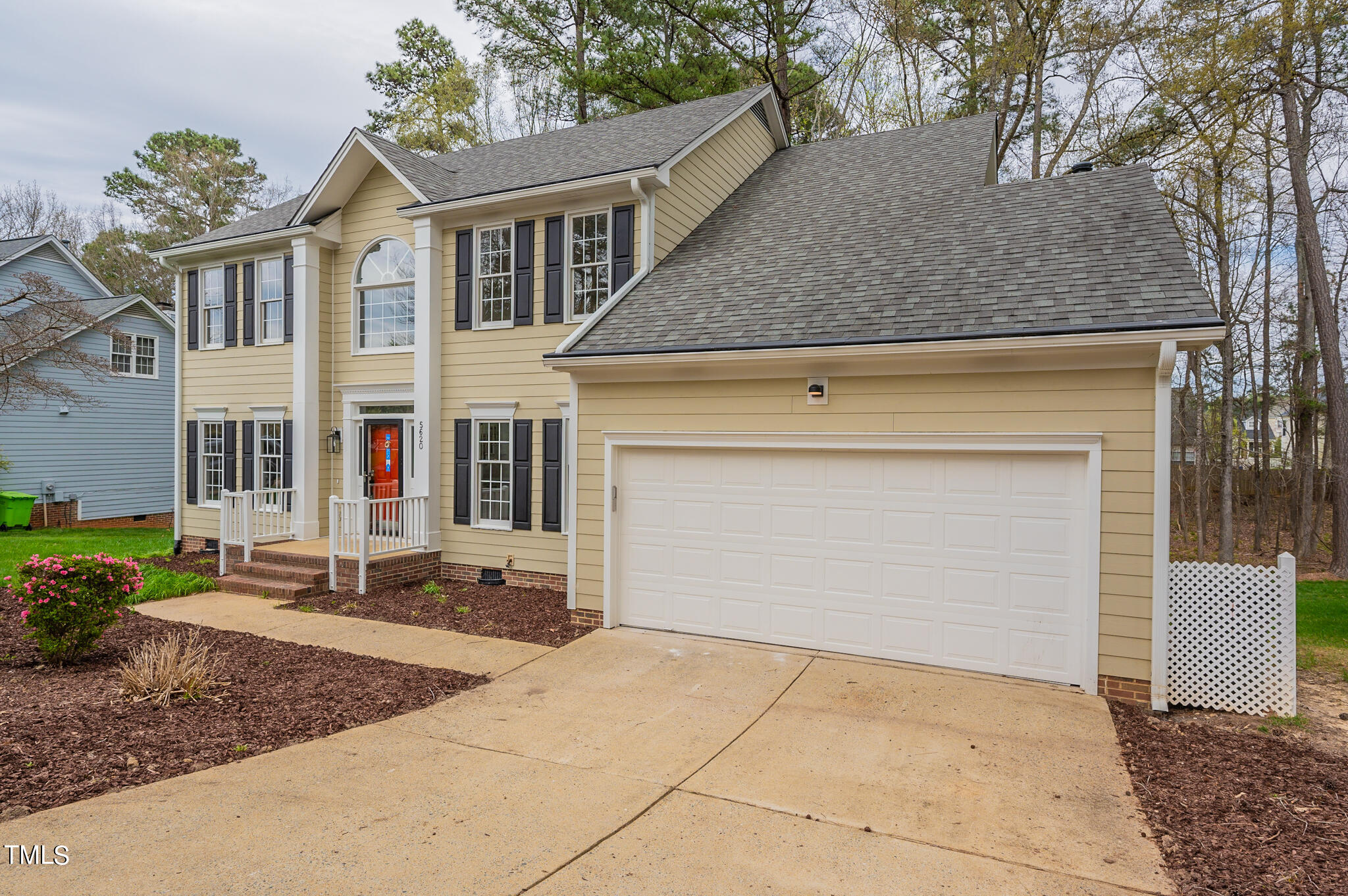 5620 Raddington Street Raleigh, NC 27613 - Photo 29 of 41 a front view of a house with a yard and garage