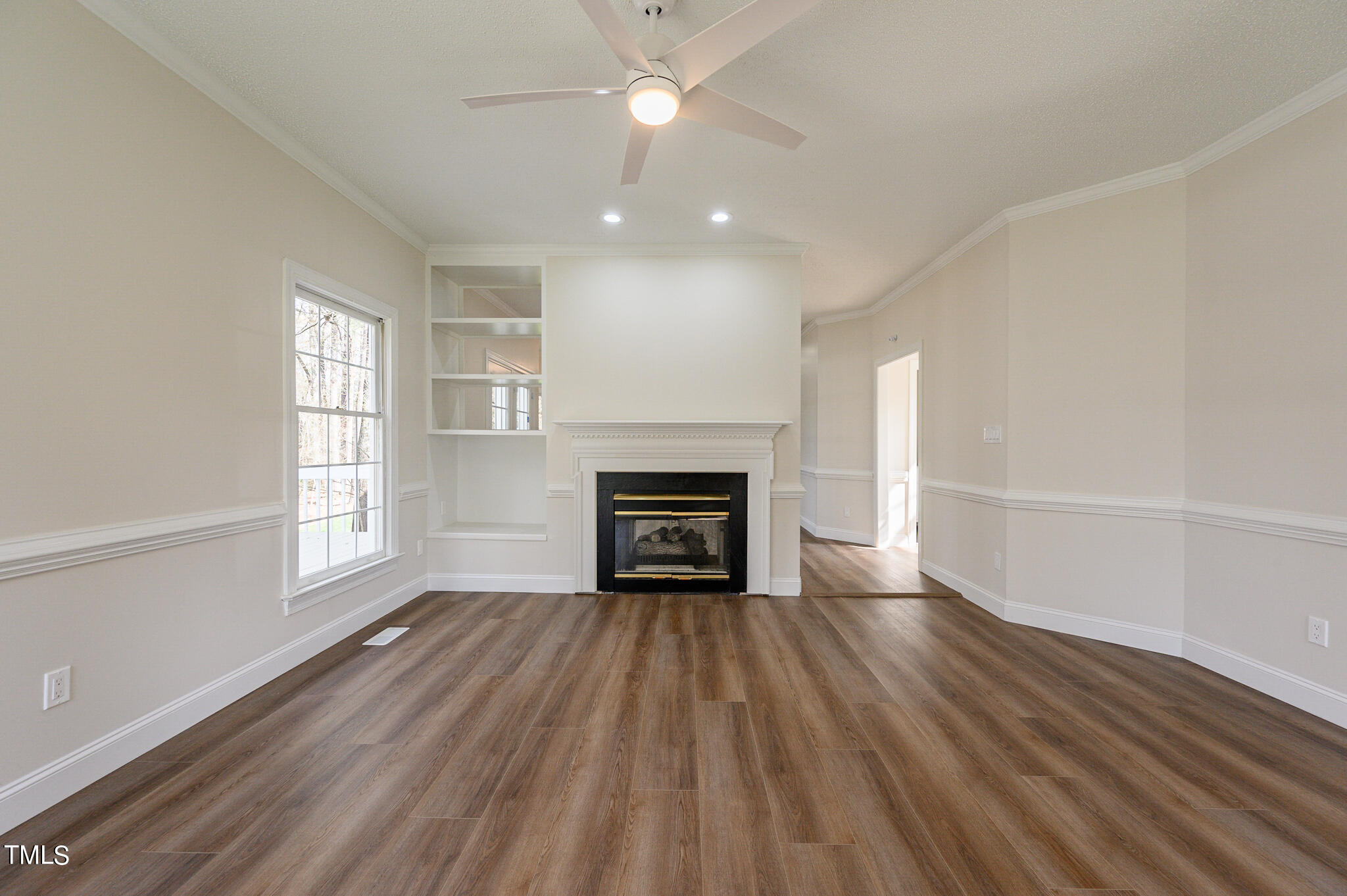 5620 Raddington Street Raleigh, NC 27613 - Photo 3 of 41 an empty room with windows and fireplace