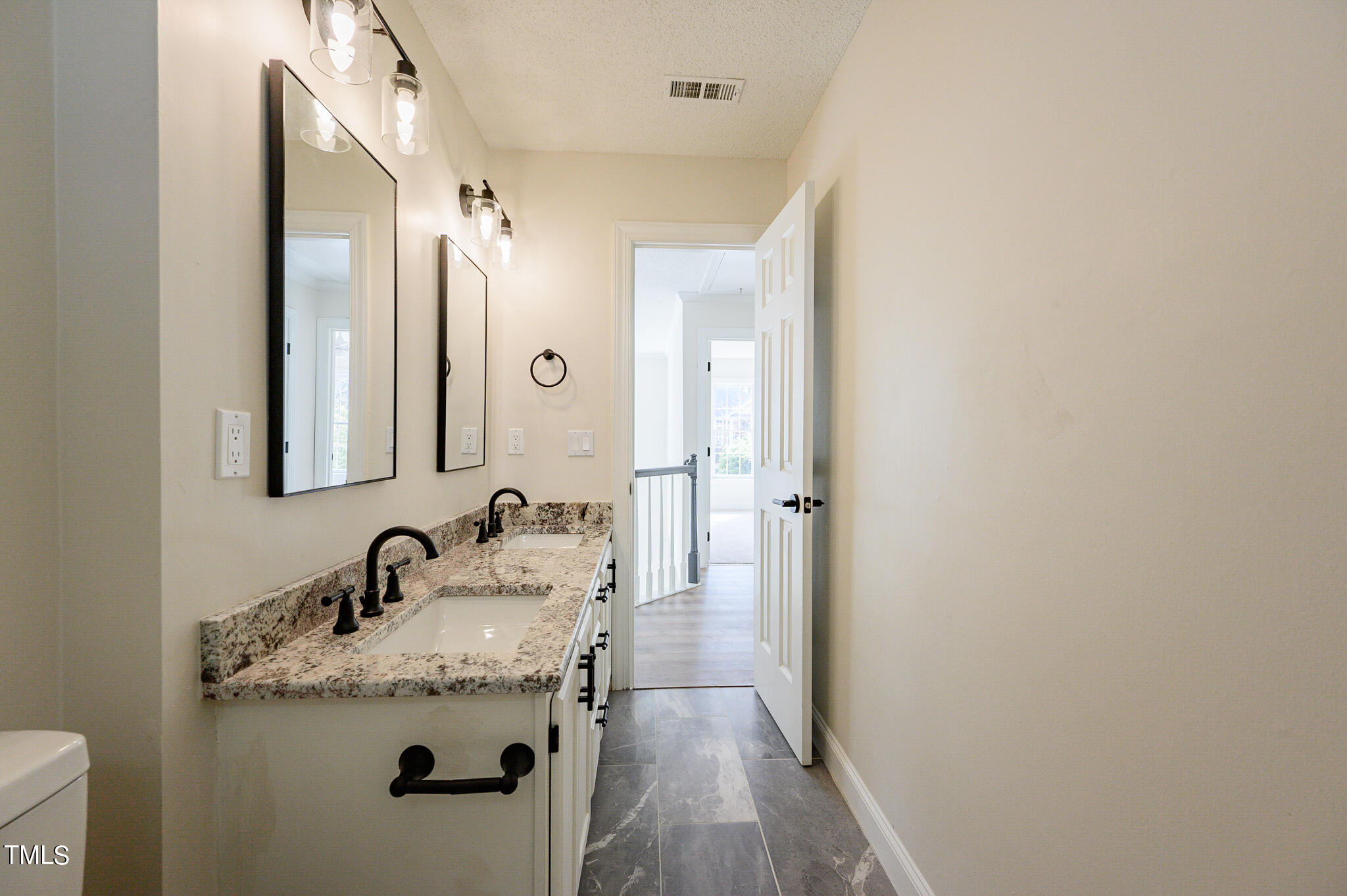 5620 Raddington Street Raleigh, NC 27613 - Photo 36 of 41 a bathroom with a granite countertop sink and a mirror