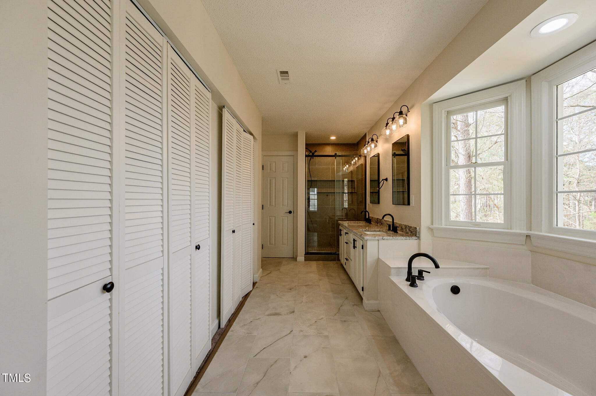 5620 Raddington Street Raleigh, NC 27613 - Photo 6 of 41 a bathroom with a bathtub and a shower