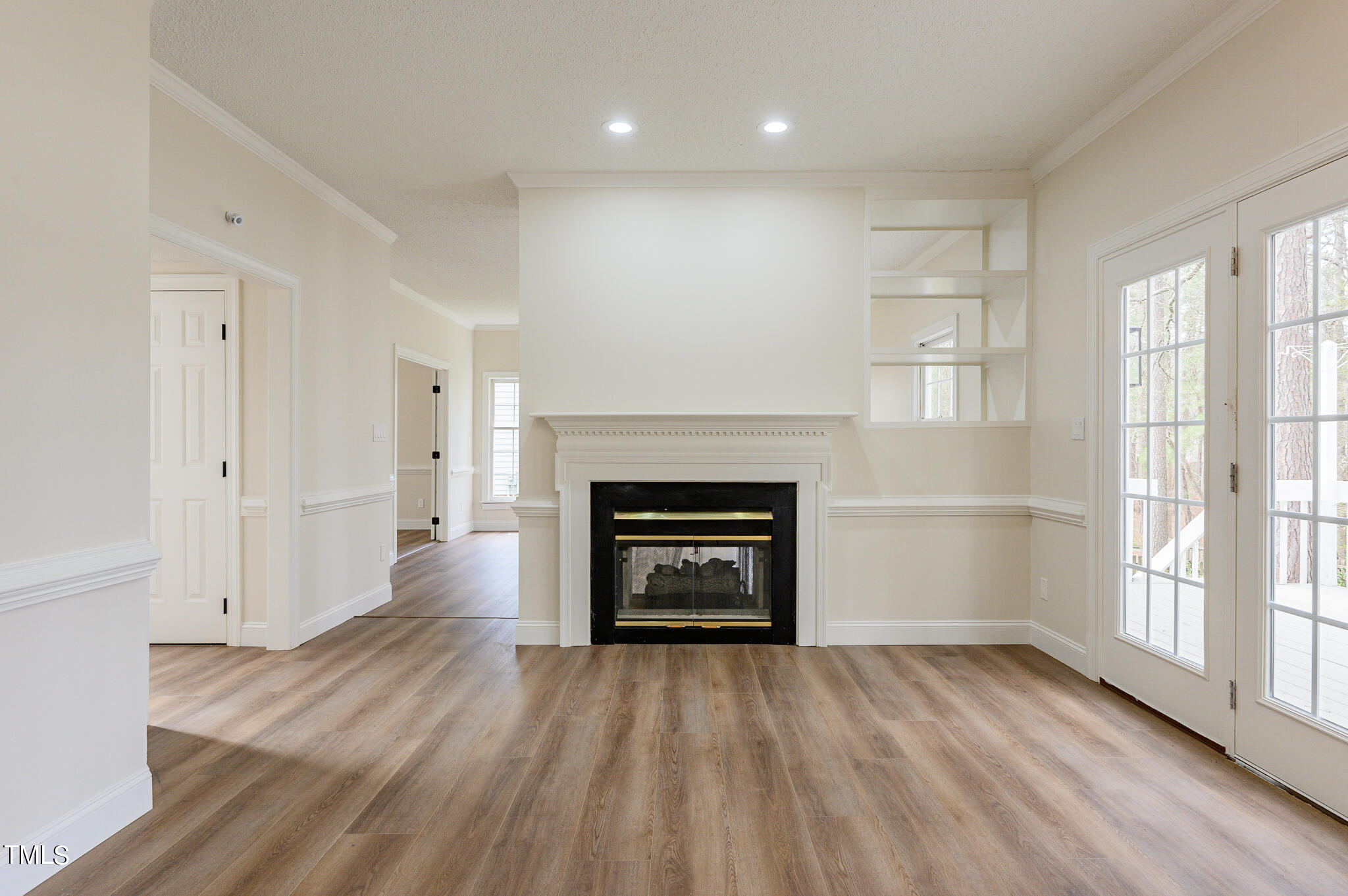 5620 Raddington Street Raleigh, NC 27613 - Photo 10 of 41 a view of an empty room with a fireplace and a window