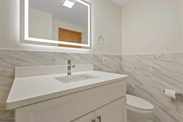 a bathroom with a sink a toilet and mirror