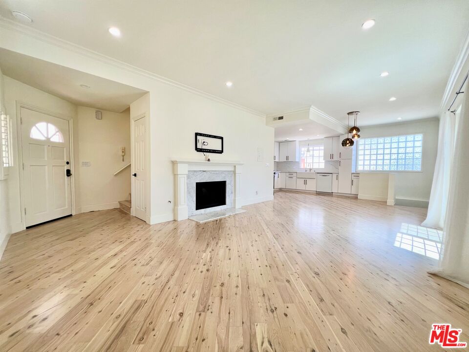 1128 17th Street, Unit E Santa Monica, CA 90403 - Photo 1 of 25 a view of empty room with wooden floor and window
