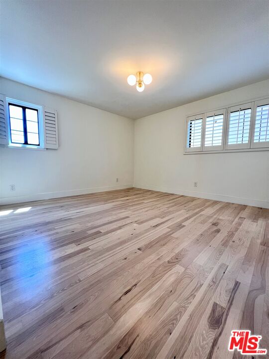 1128 17th Street, Unit E Santa Monica, CA 90403 - Photo 13 of 25 a view of empty room with wooden floor and fan