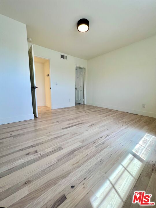 1128 17th Street, Unit E Santa Monica, CA 90403 - Photo 17 of 25 a view of an empty room and wooden floor