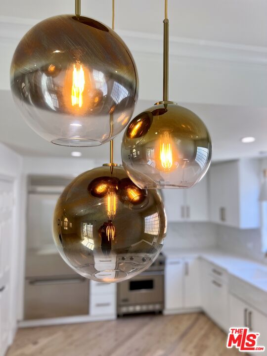 1128 17th Street, Unit E Santa Monica, CA 90403 - Photo 6 of 25 a kitchen with a stove and a mirror