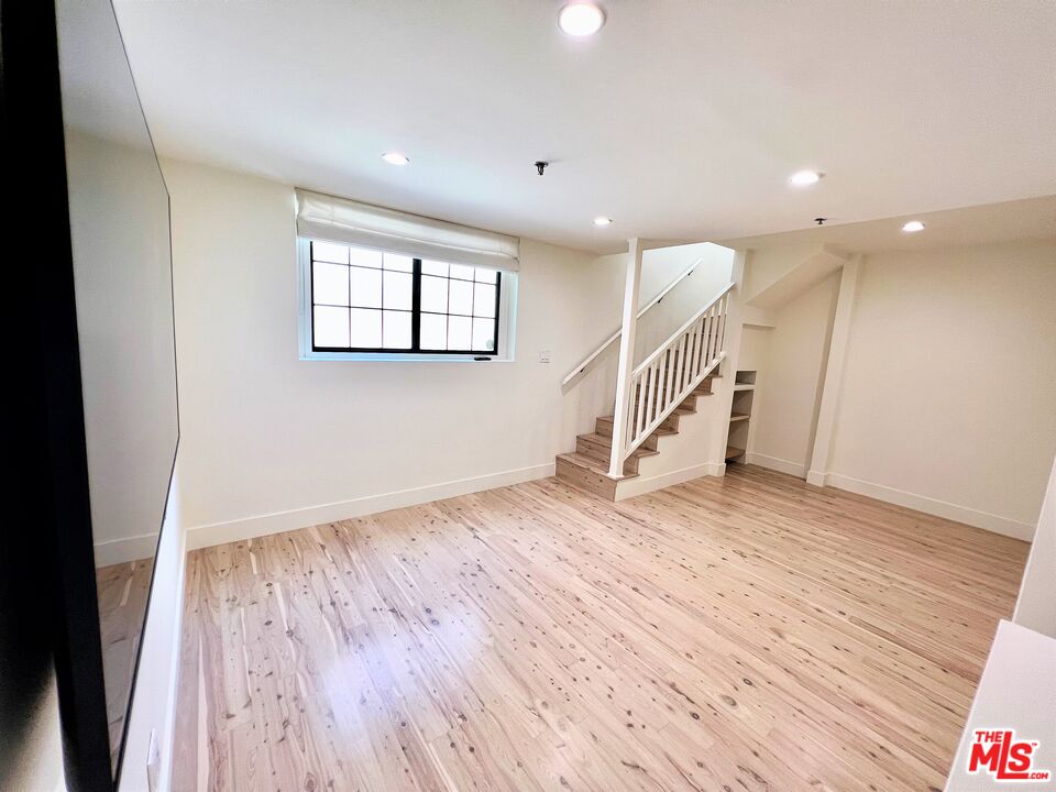 1128 17th Street, Unit E Santa Monica, CA 90403 - Photo 7 of 25 wooden floor in an empty room with a window
