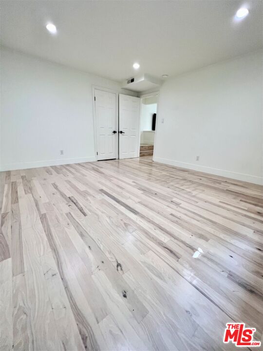 1128 17th Street, Unit E Santa Monica, CA 90403 - Photo 10 of 25 a view of empty room with wooden floor