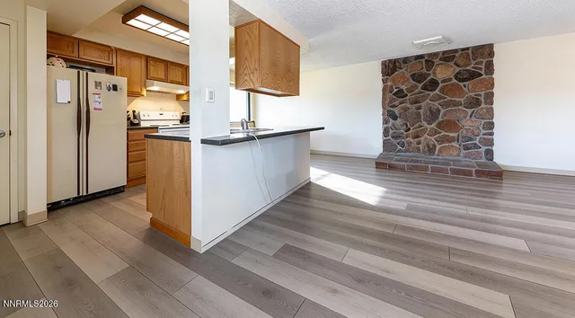 a kitchen with stainless steel appliances granite countertop a refrigerator and a stove